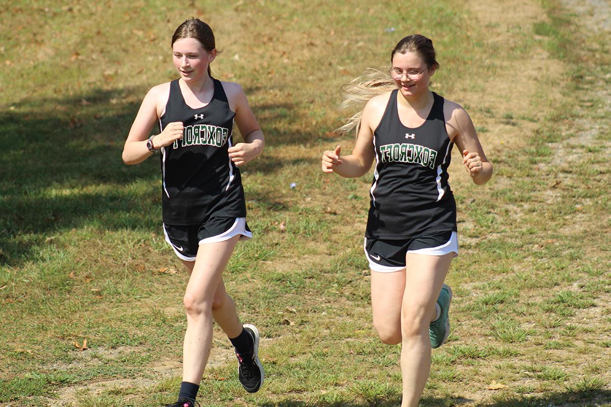 two-athletes-running-cross-country-course